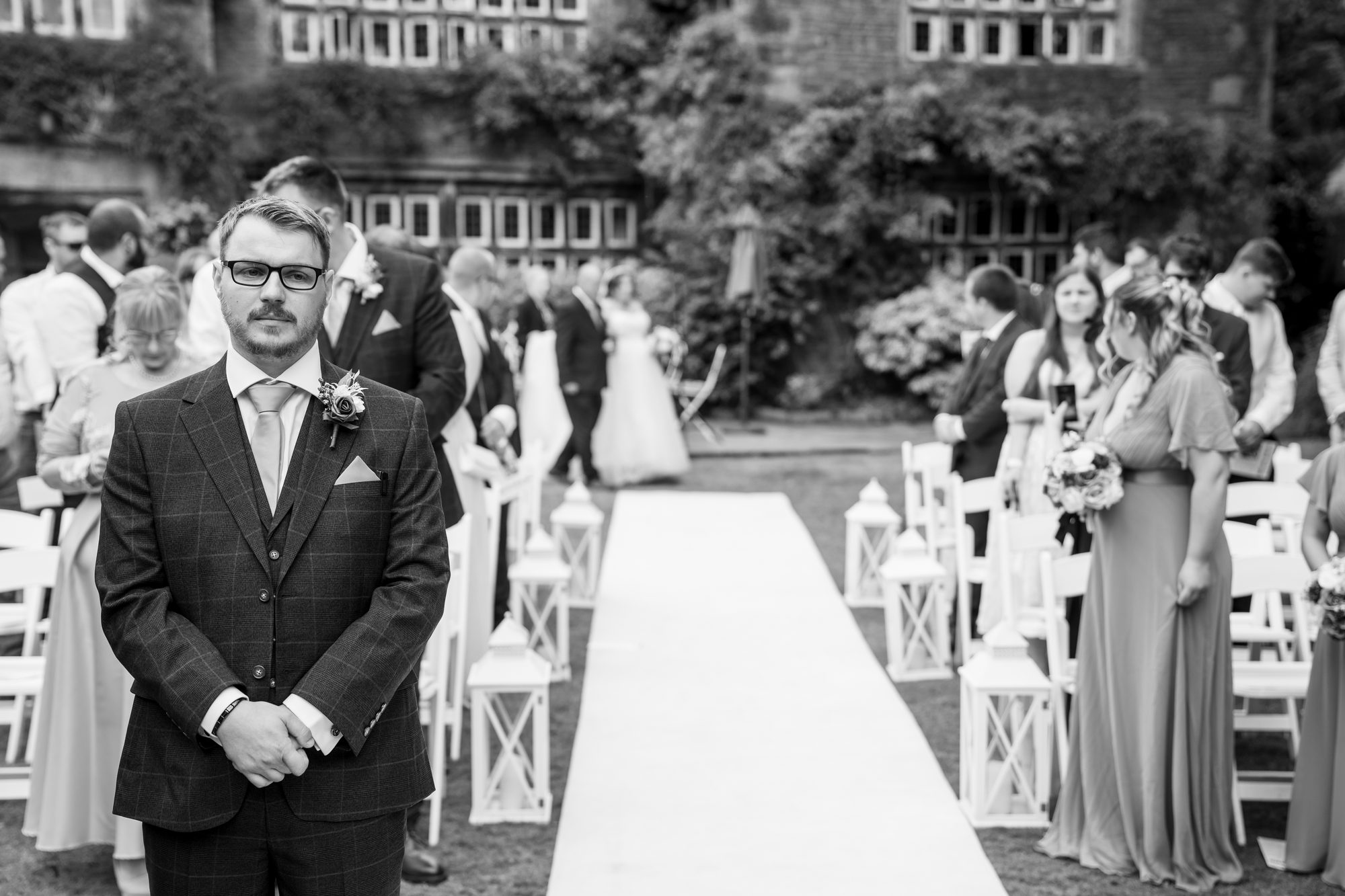 Scott waiting at the top of the aisle in the garden before the ceremony